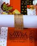 A set of gold-plated chain bangles displayed on a white cylindrical stand, with SAWRA GOLD branding visible on the packaging in the background.