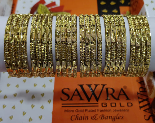 Gold bangles on a white roll with Sawra Gold branding in the background