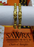 Gold bangles on a white cylindrical object with 'Sawra Gold' branding in the background.