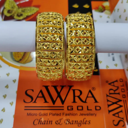 Gold bangles on a Sawra Gold branded card with a blurred background