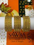 Three gold-plated chain bangles with intricate heart and diamond patterns, displayed on a white cylindrical stand in front of a branded orange and white Sawra Gold packaging background.